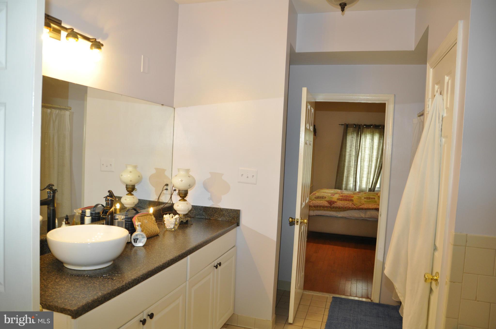 113 River Road Occoquan, VA 22125 - Photo 11 of 18 a bathroom with a granite countertop sink and a mirror