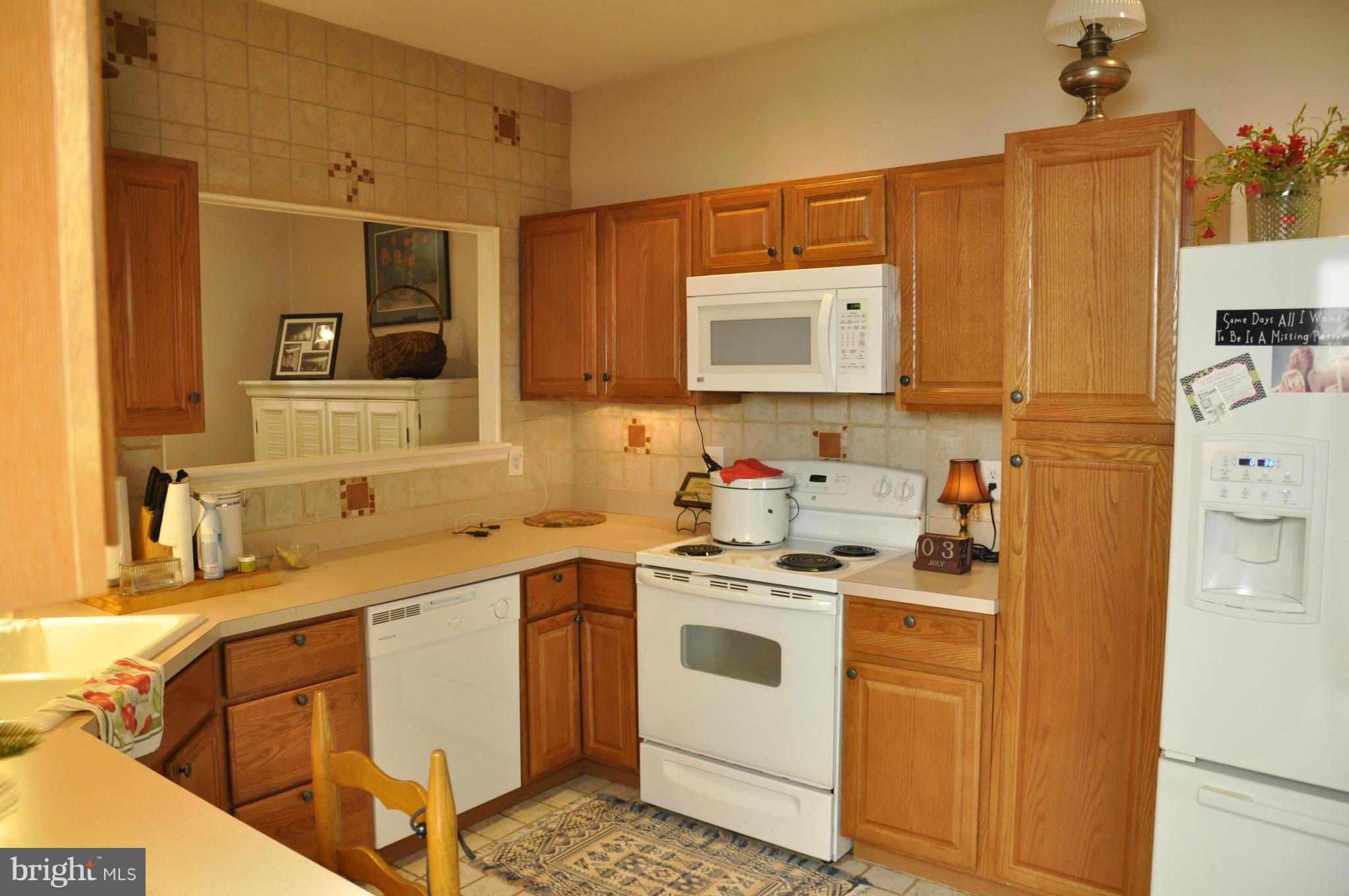 113 River Road Occoquan, VA 22125 - Photo 3 of 18 a view of a kitchen with a sink and wooden cabinets