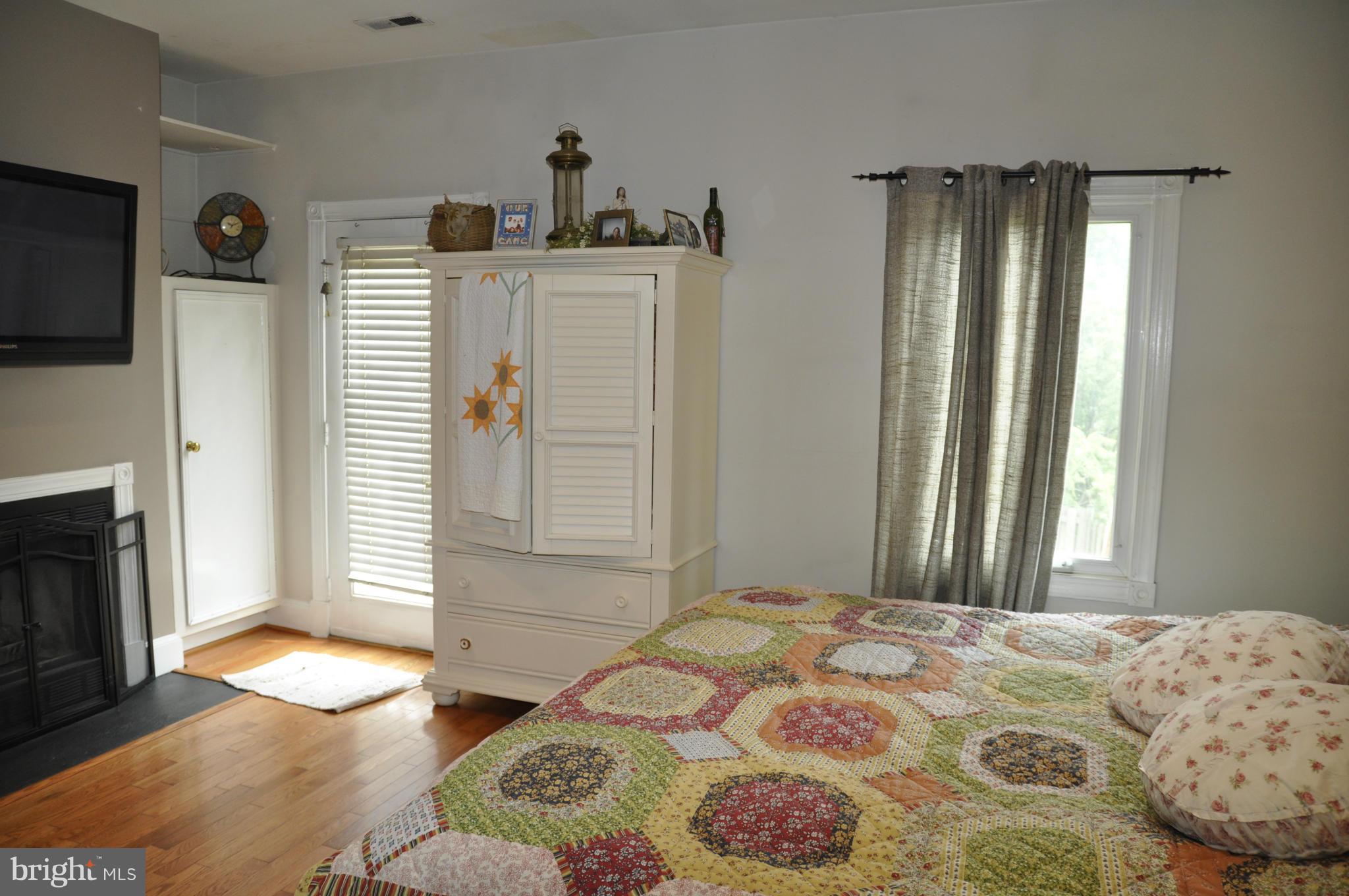 113 River Road Occoquan, VA 22125 - Photo 10 of 18 a bedroom with a bed and a flat tv screen on dresser