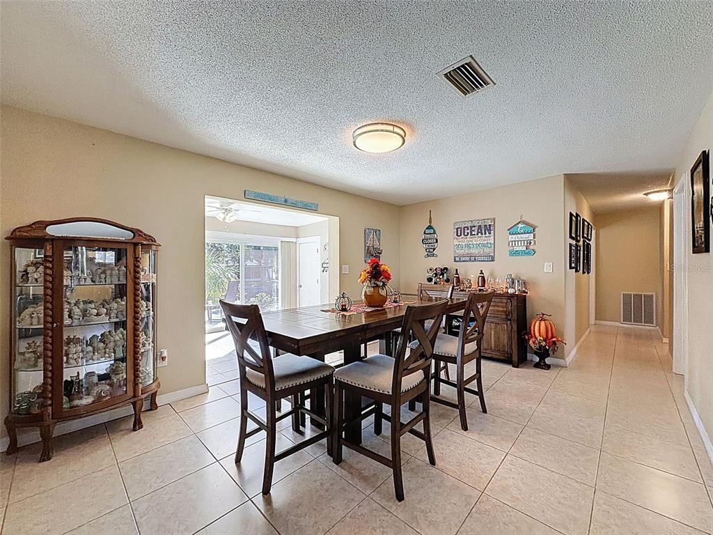 8716 Green Street Port Richey, FL 34668 - Photo 12 of 42 a view of a dining room with furniture and window