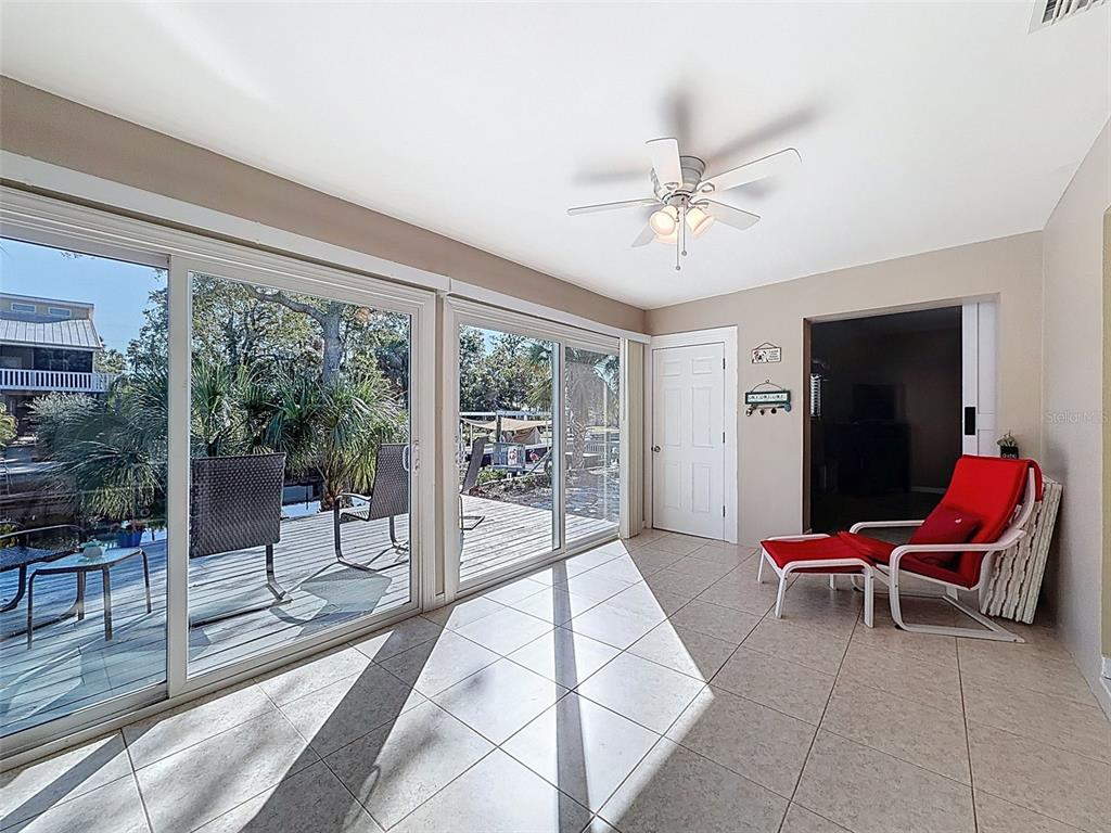 8716 Green Street Port Richey, FL 34668 - Photo 15 of 42 a living room with furniture and a floor to ceiling window