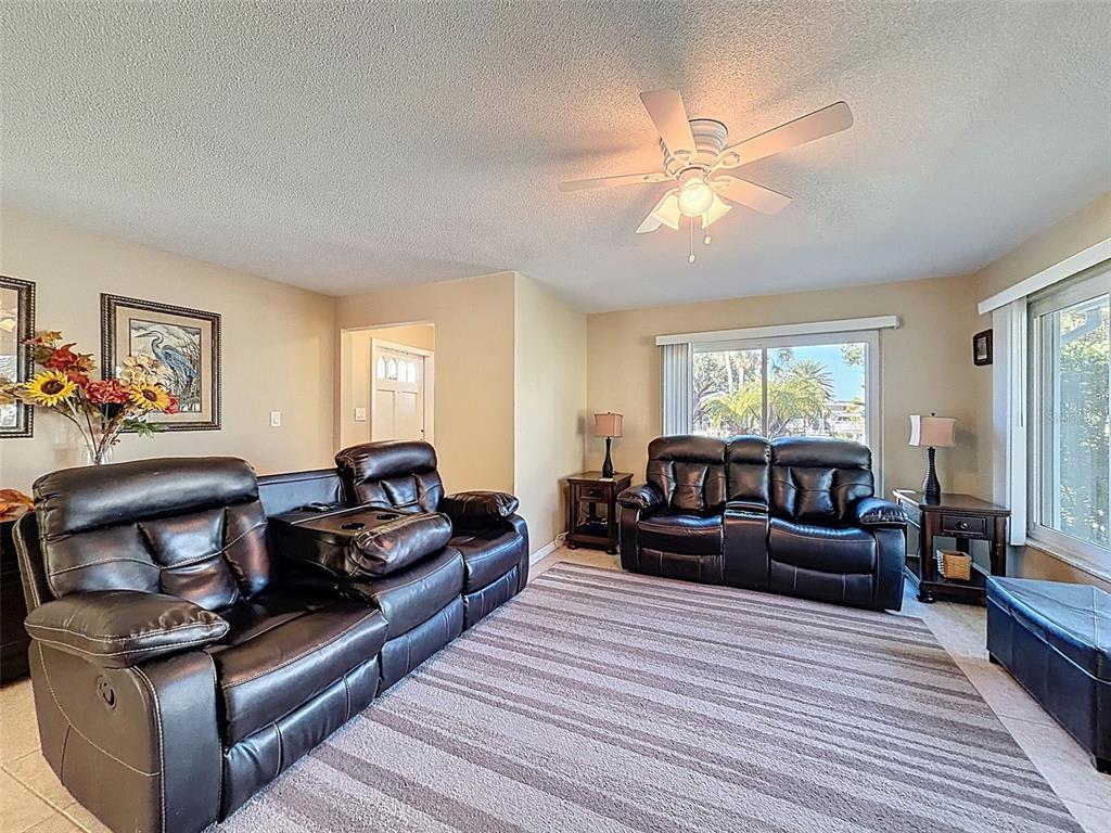 8716 Green Street Port Richey, FL 34668 - Photo 16 of 42 a living room with furniture and a wooden floor