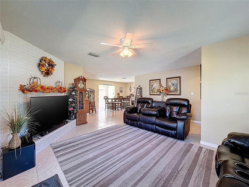 8716 Green Street Port Richey, FL 34668 - Photo 17 of 42 a living room with furniture and a flat screen tv