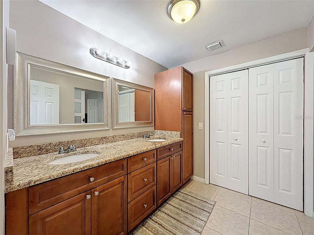 8716 Green Street Port Richey, FL 34668 - Photo 22 of 42 a bathroom with a granite countertop sink and a mirror
