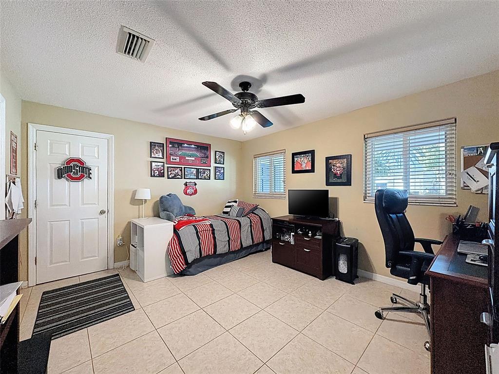 8716 Green Street Port Richey, FL 34668 - Photo 25 of 42 a living room with furniture and a flat screen tv