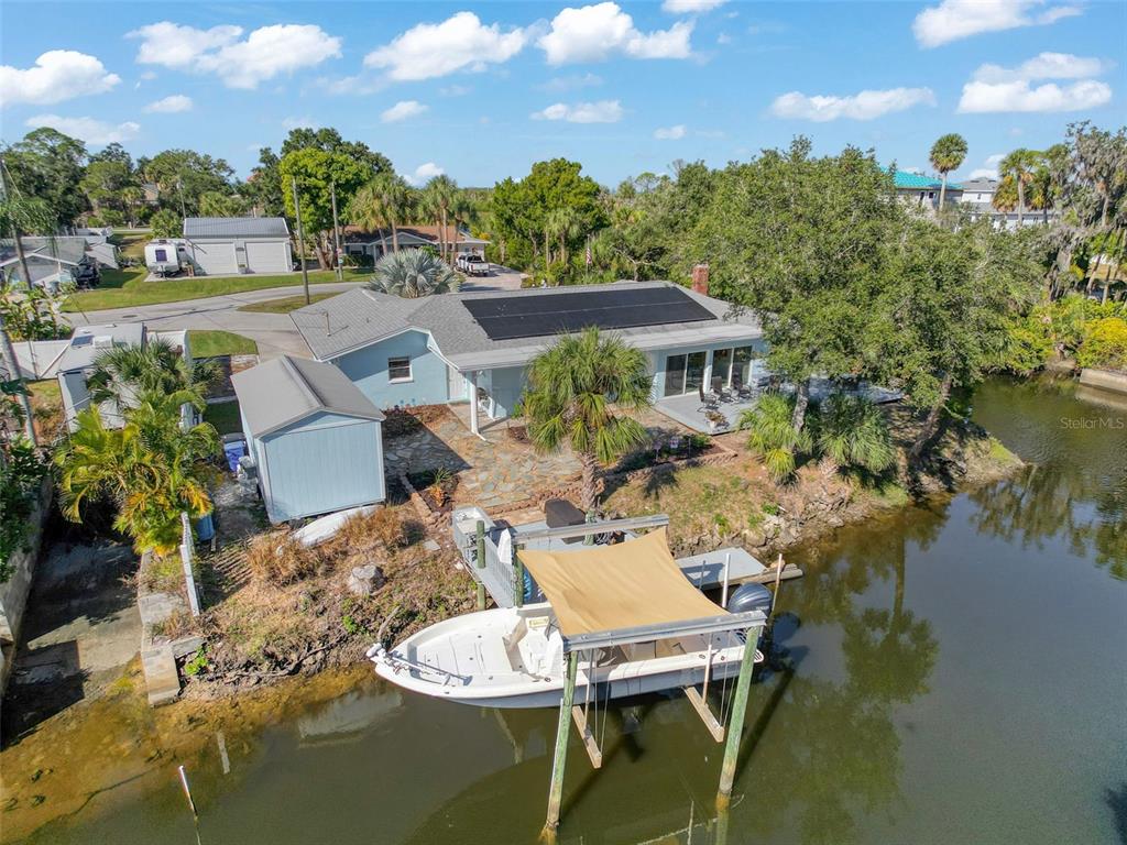 8716 Green Street Port Richey, FL 34668 - Photo 32 of 42 a view of a patio with couches table and chairs and potted plants