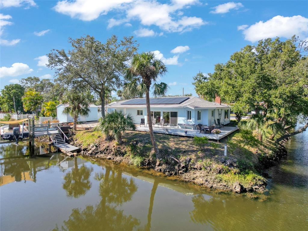 8716 Green Street Port Richey, FL 34668 - Photo 33 of 42 a view of a lake with house swimming pool and outdoor space