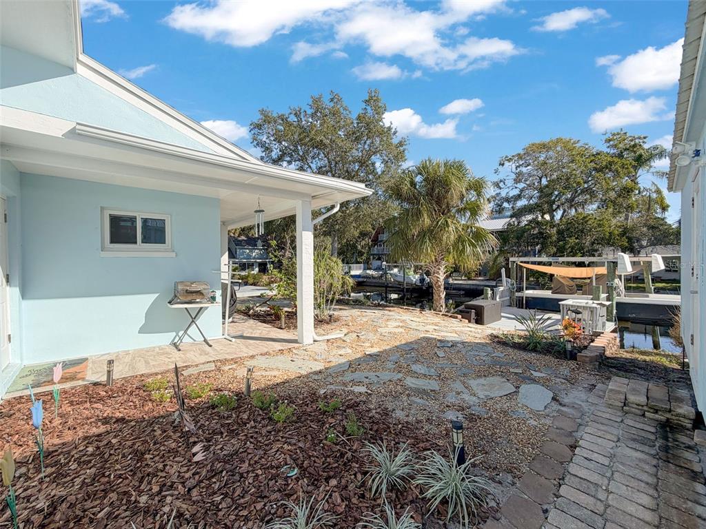 8716 Green Street Port Richey, FL 34668 - Photo 35 of 42 a patio with a table and chairs and potted plants