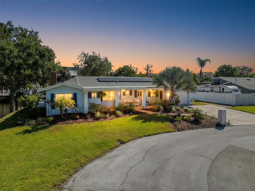 8716 Green Street Port Richey, FL 34668 - Photo 40 of 42 a view of a house with backyard sitting area and garden
