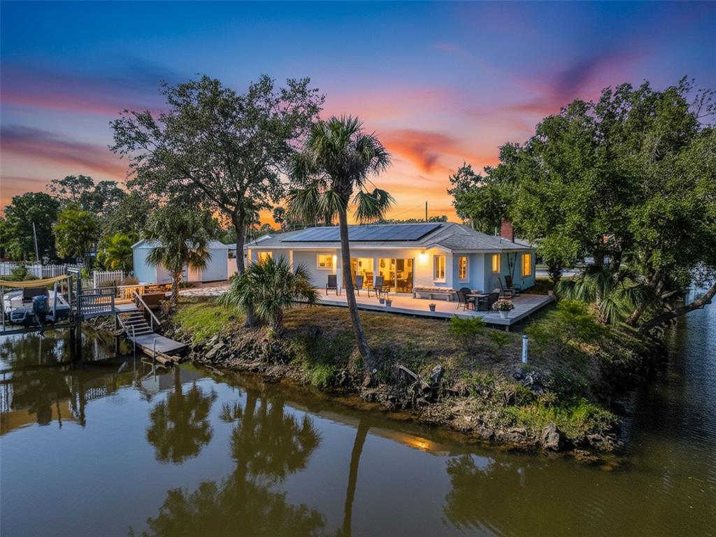 8716 Green Street Port Richey, FL 34668 - Photo 41 of 42 a view of house with swimming pool and lake view