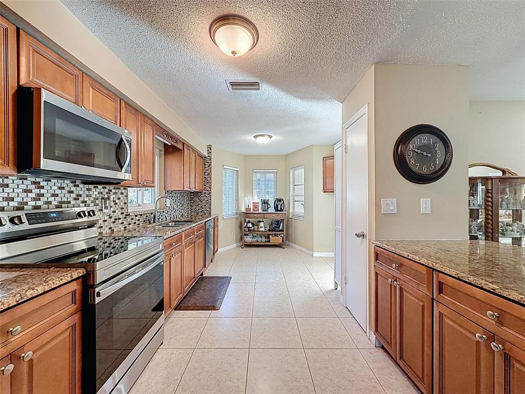 8716 Green Street Port Richey, FL 34668 - Photo 8 of 42 a kitchen with a stove and a microwave