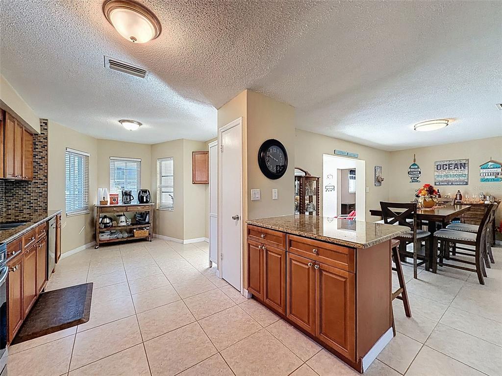 8716 Green Street Port Richey, FL 34668 - Photo 10 of 42 a large kitchen with stainless steel appliances lots of counter space and windows