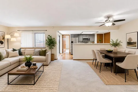 a living room with furniture wooden floor and dining table