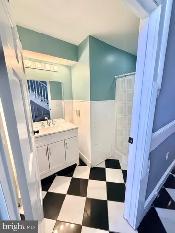 a room with a black white and white checkered floor with a black white checkered floor