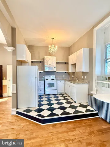 a kitchen with kitchen island granite countertop a sink cabinets and counter space