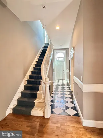 a view of entryway and hall with wooden floor