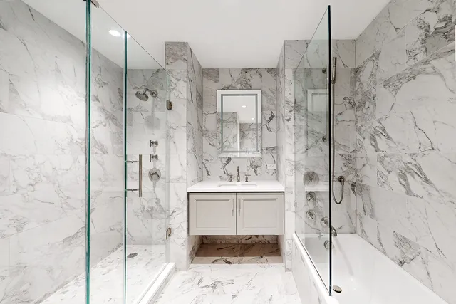 a bathroom with a sink double vanity and a shower
