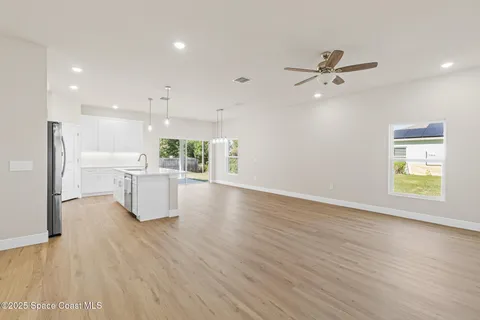 a large white kitchen with white cabinets and stainless steel appliances