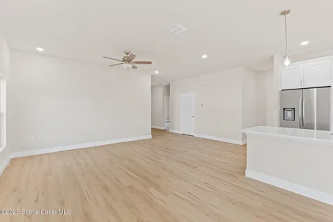 a kitchen with white cabinets and a sink