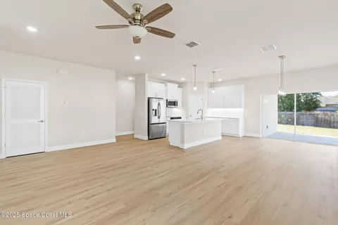 a kitchen with stainless steel appliances a refrigerator a stove a microwave and cabinets