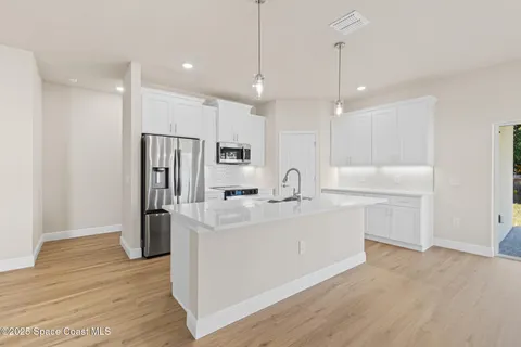 a kitchen with a stove and a microwave
