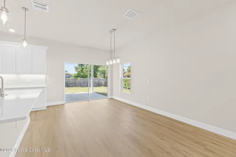 a kitchen with a sink a window and stainless steel appliances
