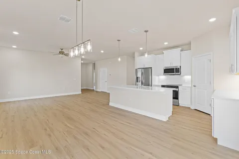 a stove top oven sitting inside of a kitchen