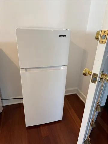 a view of closet with wooden floor