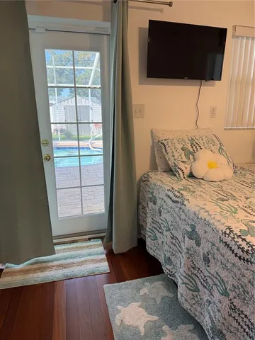 a bedroom with a bed and a flat tv screen