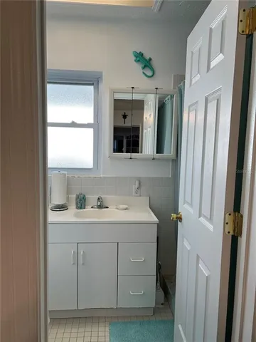 a bathroom with a double vanity sink and mirror