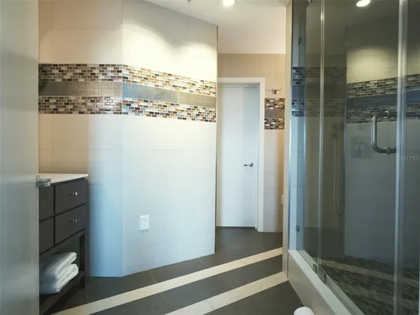 a view of a walk in closet and bathroom