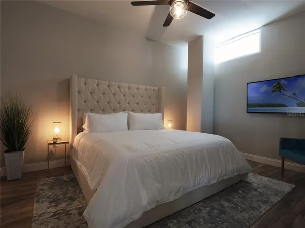 a large bed sitting in a bedroom next to a lamp