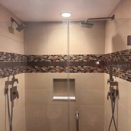 a view of a hallway with wooden floor and a cabinet