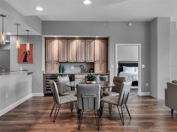 a dining room with furniture and wooden floor