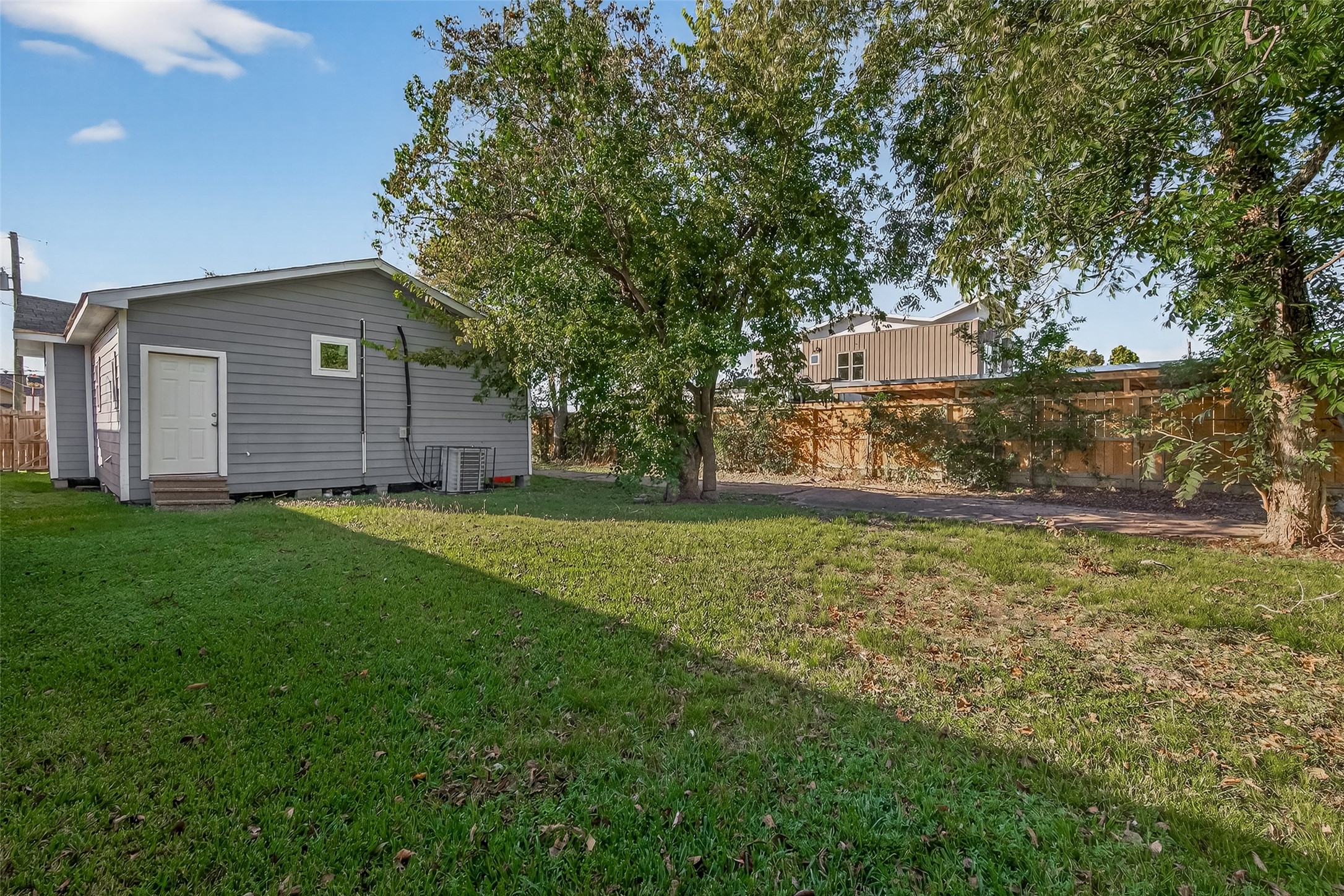 8211 Parnell Street Houston, TX 77051 - Photo 20 of 22 a view of a yard in front of a house with large tree
