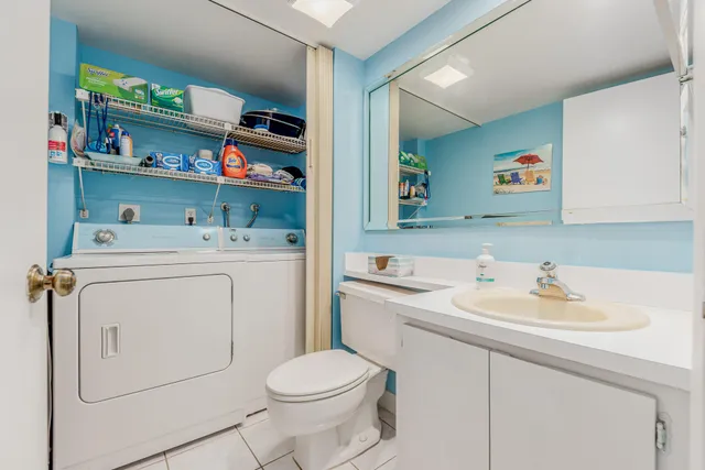 a utility room with sink dryer and washer