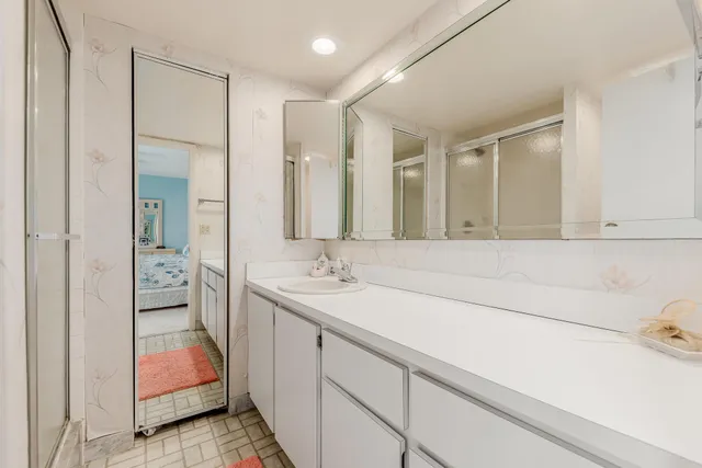 a bathroom with a sink and mirror with toilet