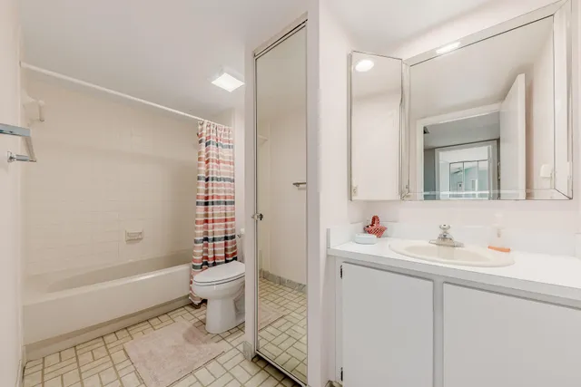 a bathroom with a sink toilet vanity and shower