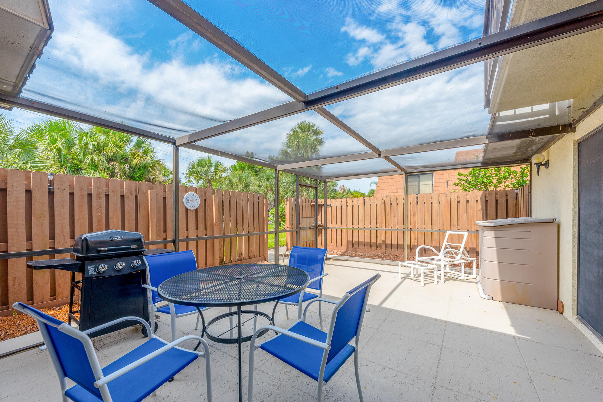 Undisclosed Address Stuart, FL 34997 - Photo 4 of 20 a view of a patio with table and chairs and wooden fence