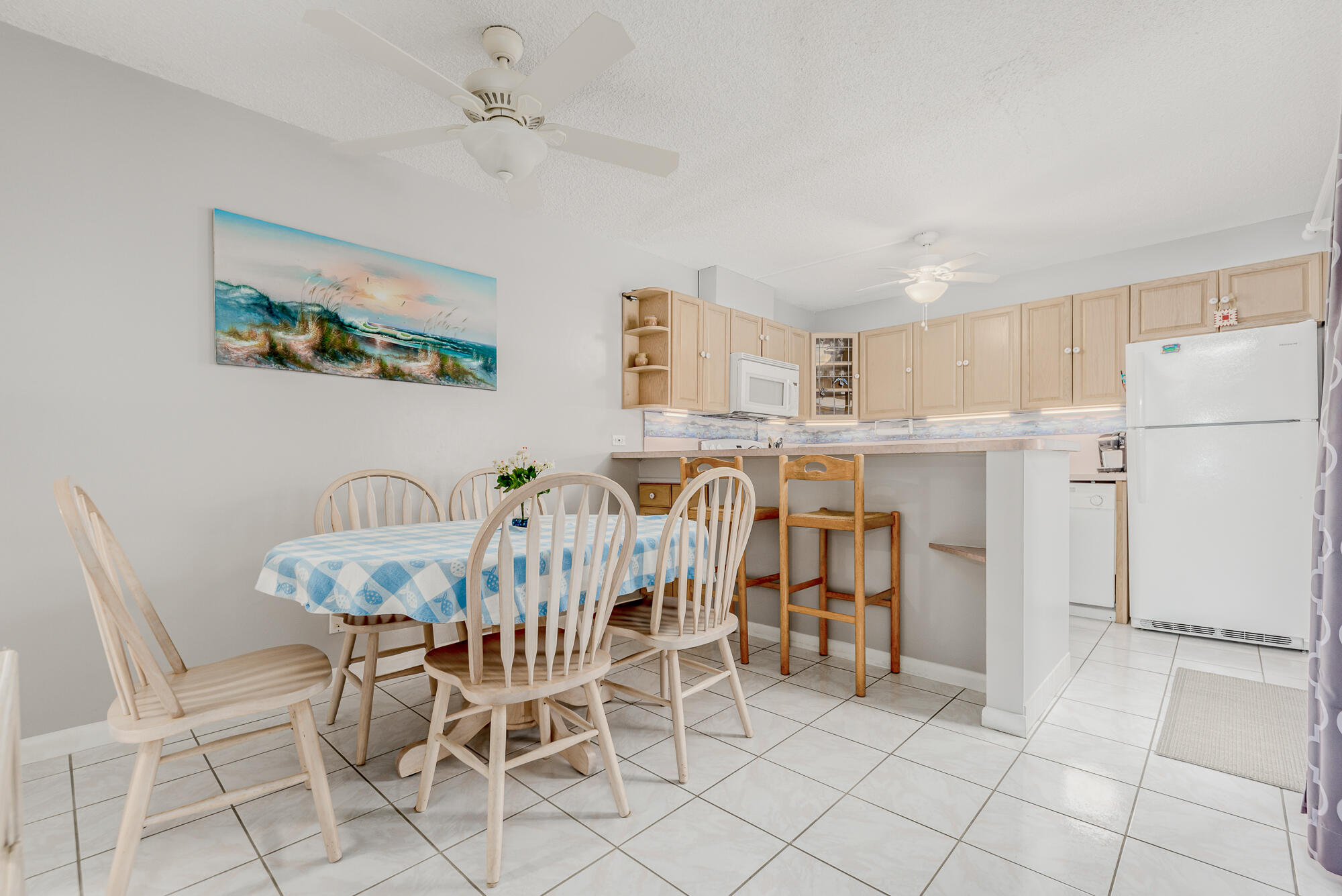 Undisclosed Address Stuart, FL 34997 - Photo 8 of 20 a view of a dining room with furniture and a chandelier fan