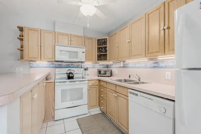 a kitchen with cabinets appliances a sink and a counter top space