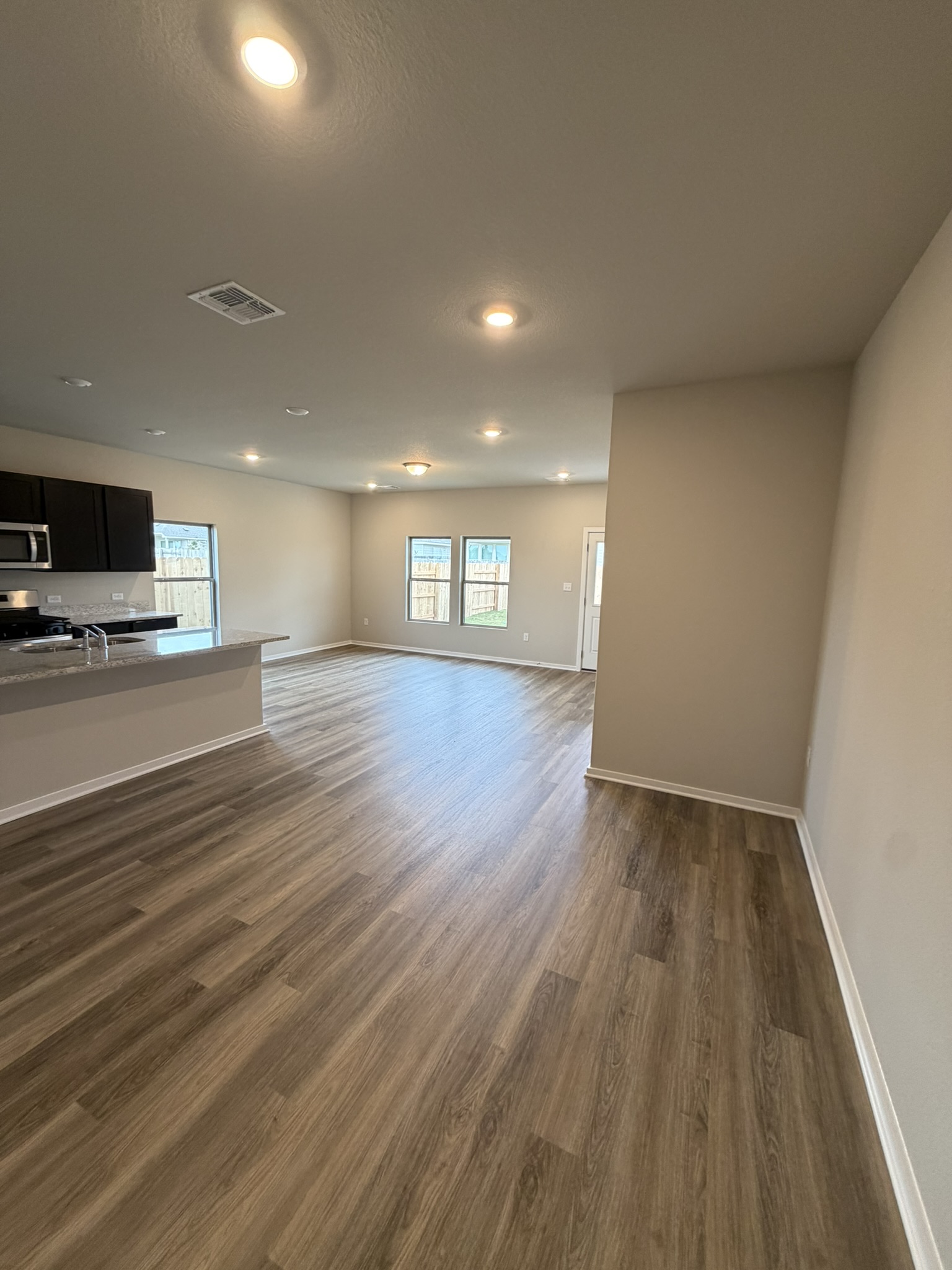 13717 Ryan Range Lane Elgin, TX 78621 - Photo 4 of 20 Family Room, Kitchen & Casual Dining