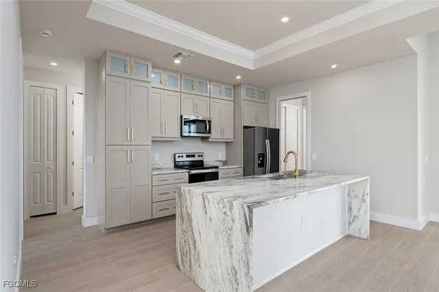 a kitchen with stainless steel appliances a refrigerator stove microwave and sink