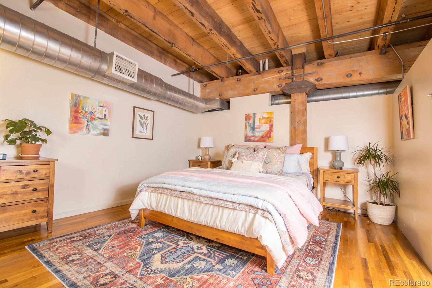 1801 Wynkoop Street, Unit 315 Denver, CO 80202 - Photo 11 of 26 a bedroom with a bed and wooden floor
