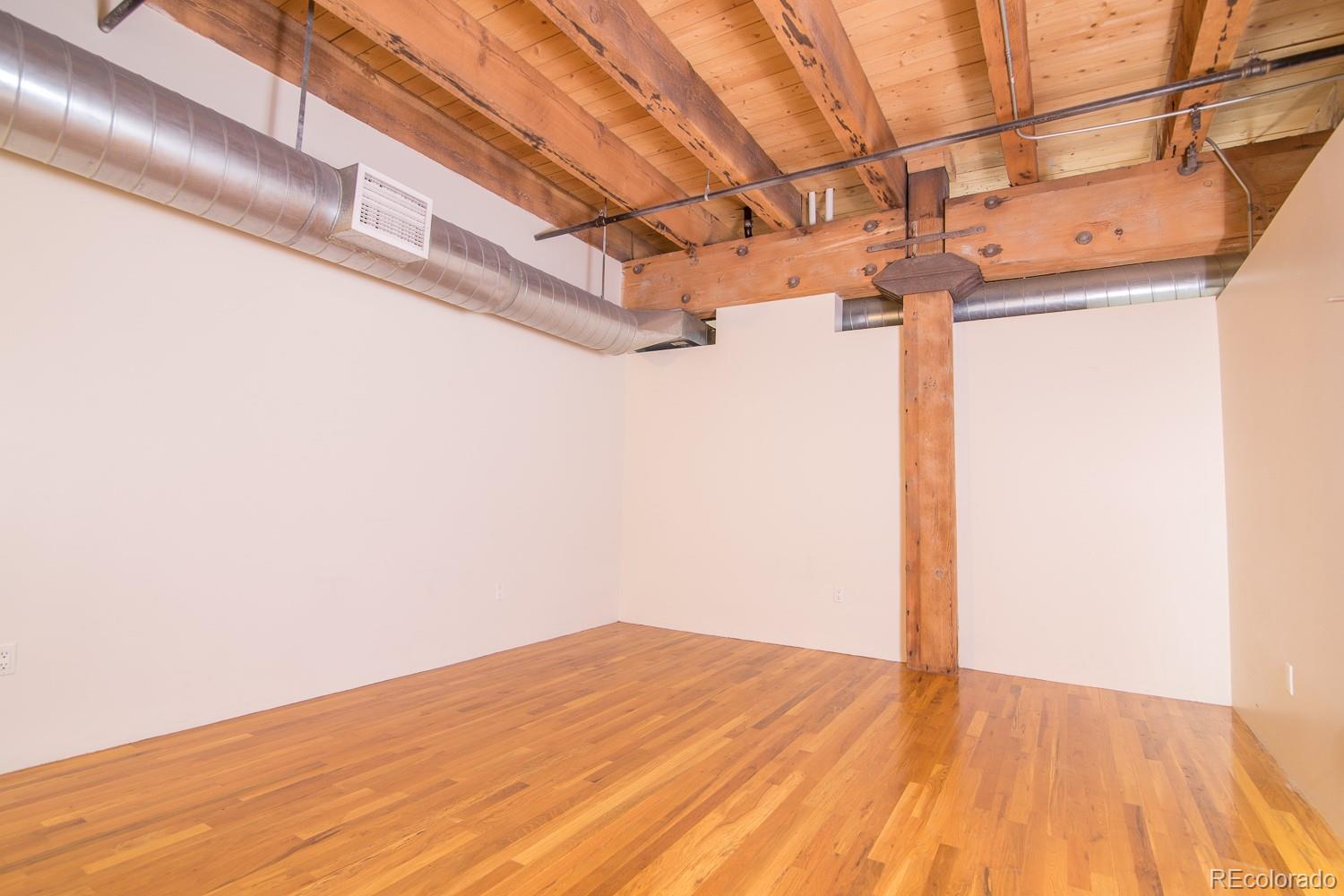 1801 Wynkoop Street, Unit 315 Denver, CO 80202 - Photo 12 of 26 a view of a room with a wooden floor