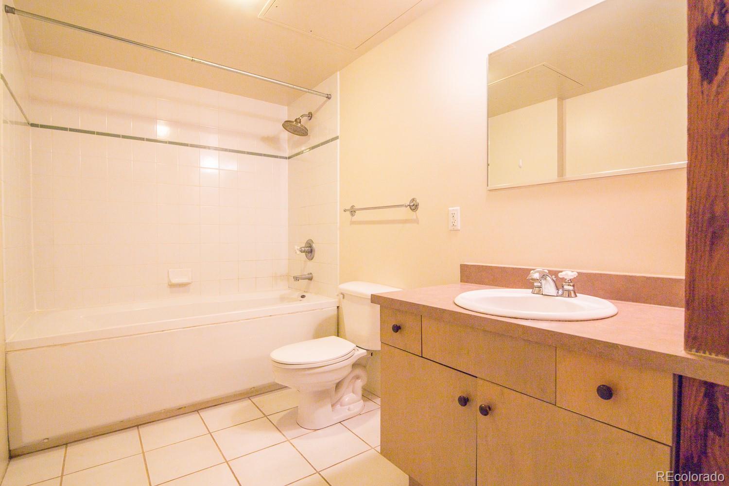 1801 Wynkoop Street, Unit 315 Denver, CO 80202 - Photo 16 of 26 a bathroom with a sink a toilet and shower