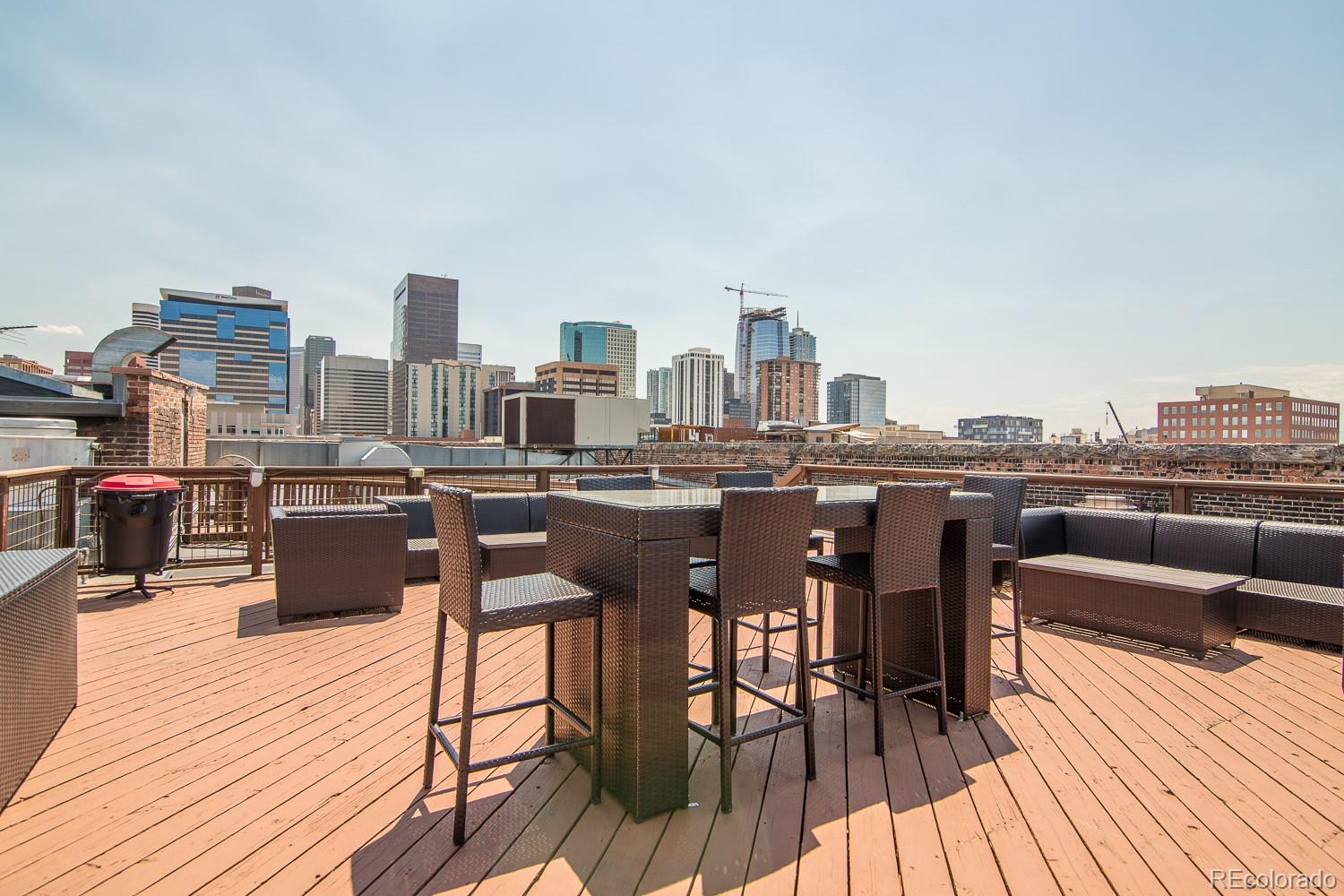 1801 Wynkoop Street, Unit 315 Denver, CO 80202 - Photo 21 of 26 a view of a rooftop deck with chairs and wooden floor
