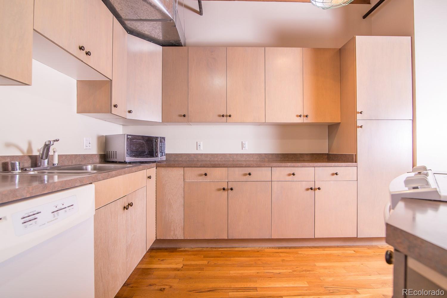 1801 Wynkoop Street, Unit 315 Denver, CO 80202 - Photo 8 of 26 a kitchen with white cabinets and sink