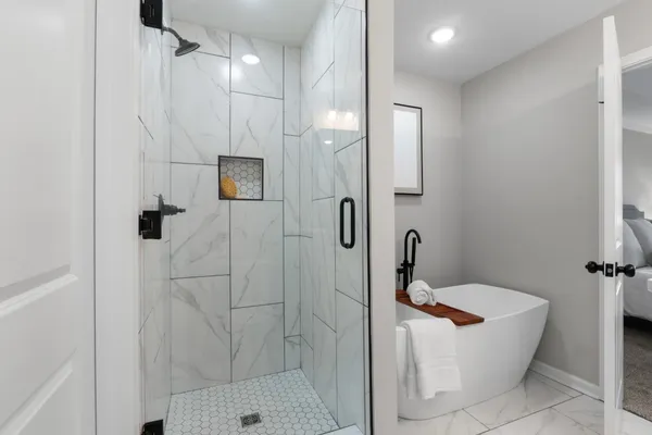 a bathroom with a sink a toilet and shower