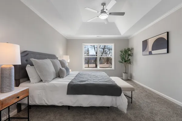 a bedroom with a large bed and a window